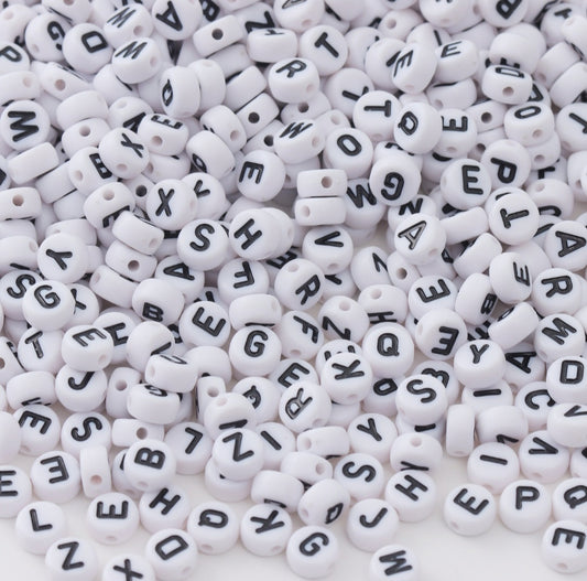 White Beads with Black Letters